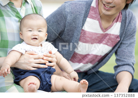 Family holding a baby Family holding a baby 137352888
