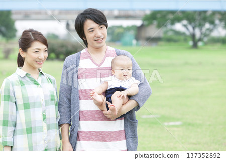 Family holding a baby Family holding a baby 137352892