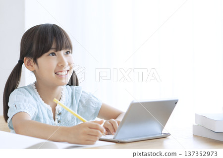 Girl studying on a tablet 137352973