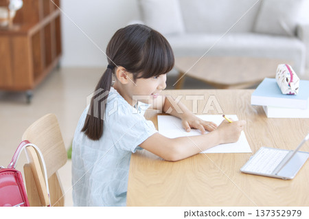 Girl studying on a tablet Girl studying on a tablet 137352979