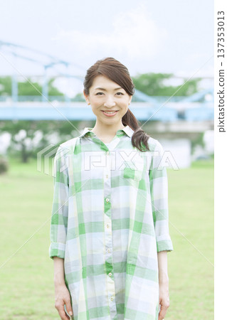 Portrait of a woman standing in a park 137353013