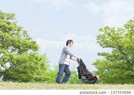 Father pushing a stroller 137353098