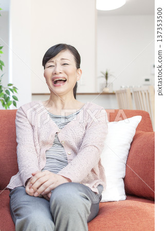 A woman relaxing on the sofa A woman relaxing on the sofa 137353500