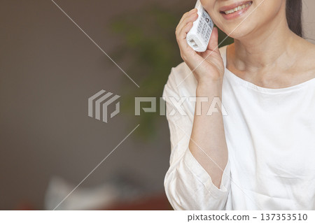 Woman speaking on the phone Woman speaking on the phone 137353510