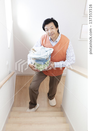 Man carrying laundry Man carrying laundry 137353516