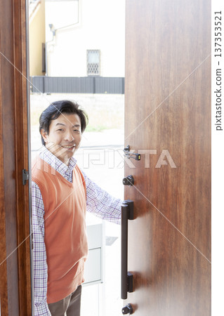 A man opens the front door A man opens the front door 137353521