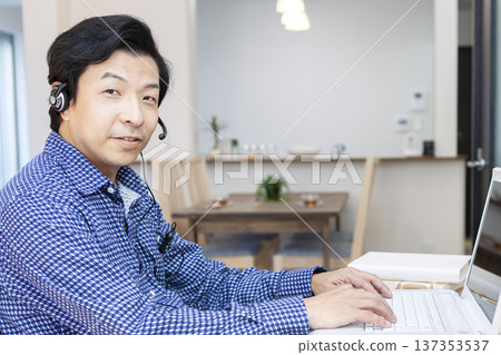 A man who operates a personal computer 137353537