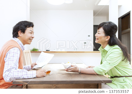 A couple having a conversation at the dining table A couple having a conversation at the dining table 137353557