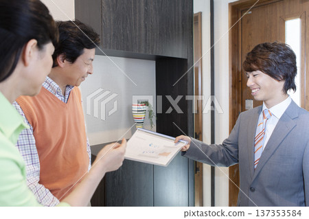 A couple having a meeting with a salesman A couple having a meeting with a salesman 137353584
