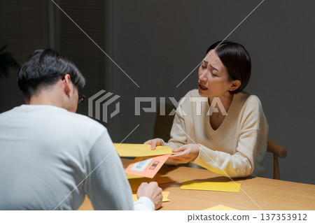 A couple struggling with a lot of bills A couple struggling with a lot of bills 137353912