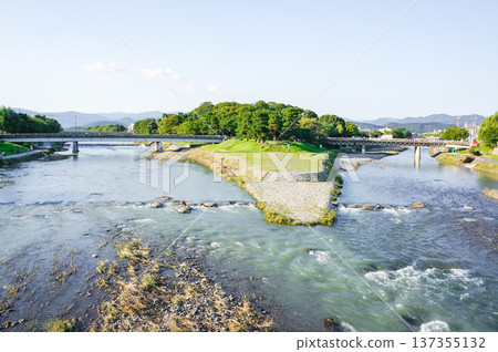 A tranquil river and lush landscape 137355132