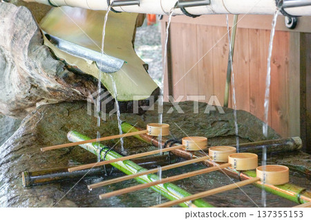 Pure water from the chozuya (purification fountain) and a traditional ladle Pure water from the chozuya (purification fountain) and a traditional ladle 137355153