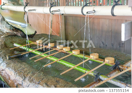 Pure water from the chozuya (purification fountain) and a traditional ladle Pure water from the chozuya (purification fountain) and a traditional ladle 137355154