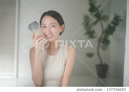Woman in sportswear holding protein Woman in sportswear holding protein 137356083