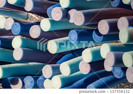 Colorful foam swimming noodles creating a vibrant abstract pattern and texture 137356132