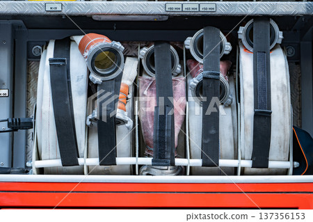 Firefighter hoses and equipment packed in a fire truck, ready for emergency response 137356153