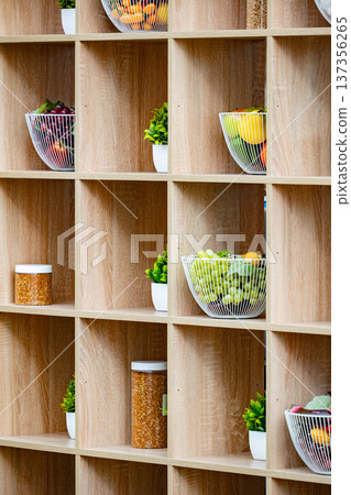 Wooden compartmental shelf organizing fresh fruits, healthy food, and decorative plants Wooden compartmental shelf organizing fresh fruits, healthy food, and decorative plants 137356265