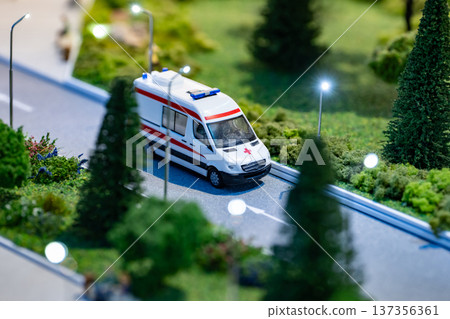 Ambulance miniature model driving on a diorama road with streetlights 137356361