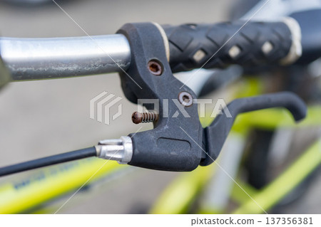 Brake lever and adjusting screw on a child's bicycle 137356381