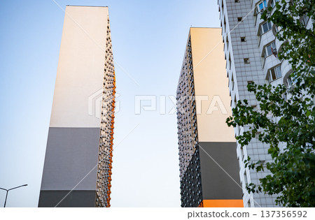 Modern residential tower in urban city with contemporary architecture and sky Modern residential tower in urban city with contemporary architecture and sky 137356592
