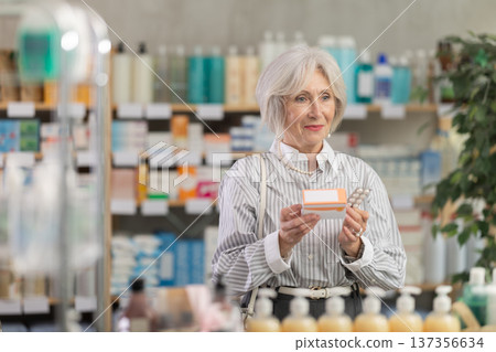 Mature woman choosing paracetamol at the pharmacy 137356634