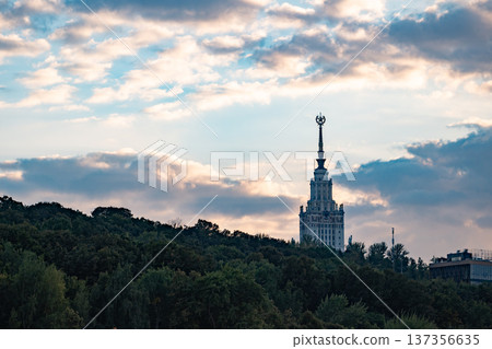 Moscow State University main building rising above hills against cloudy sky at sunset Moscow State University main building rising above hills against cloudy sky at sunset 137356635