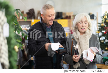 Elderly husband and wife choosing socks at Christmas sale Elderly husband and wife choosing socks at Christmas sale 137356638