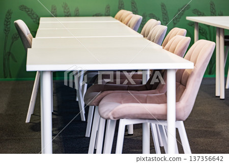 Empty modern conference room with white tables and comfortable chairs for business meeting Empty modern conference room with white tables and comfortable chairs for business meeting 137356642