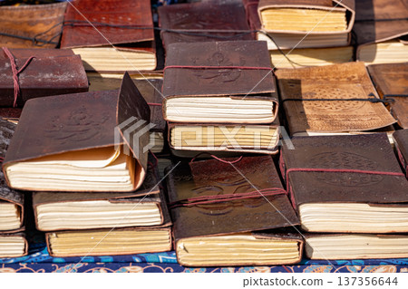 Handcrafted leather journals and diaries with embossed designs, piled for sale Handcrafted leather journals and diaries with embossed designs, piled for sale 137356644