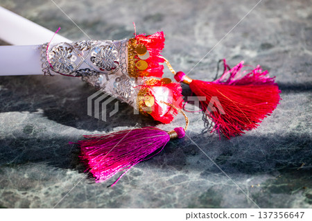 Decorative dandiya sticks with tassels, sequins, and embroidery for Navratri celebration 137356647