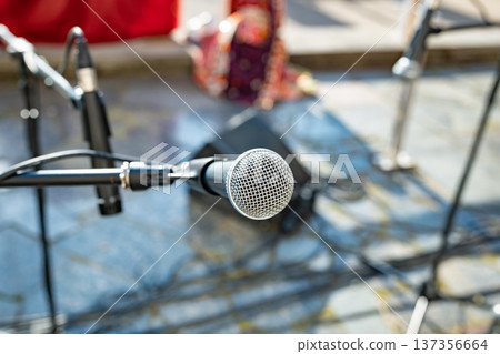 Microphone on stage preparing for an outdoor performance, sound equipment ready Microphone on stage preparing for an outdoor performance, sound equipment ready 137356664