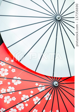 Traditional Japanese wagasa umbrellas displaying white and red cherry blossom patterns Traditional Japanese wagasa umbrellas displaying white and red cherry blossom patterns 137356690