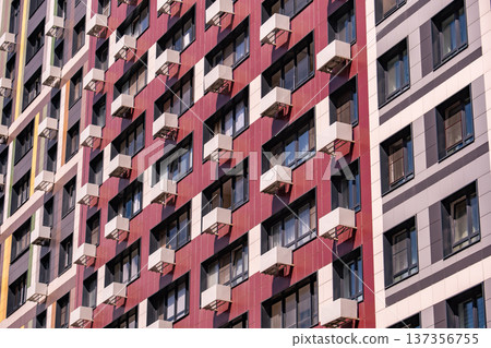 Modern residential building facade integrating air conditioning units and colorful panels 137356755