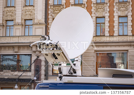 News van broadcasting live television with satellite dish antenna in urban setting News van broadcasting live television with satellite dish antenna in urban setting 137356787