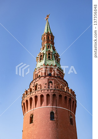 Vodovzvodnaya Tower against blue sky symbolizing Moscow Kremlin history and power Vodovzvodnaya Tower against blue sky symbolizing Moscow Kremlin history and power 137356848