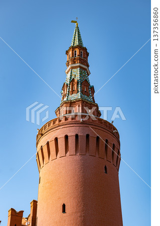 Moscow Kremlin Corner Arsenalnaya Tower with red brick architecture under blue sky Moscow Kremlin Corner Arsenalnaya Tower with red brick architecture under blue sky 137356860