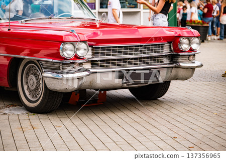 Red vintage Cadillac car showcasing classic American vehicle design with chrome details Red vintage Cadillac car showcasing classic American vehicle design with chrome details 137356965