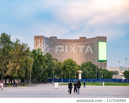 Cosmos Hotel building and park with people walking in Moscow, Russia 137356994