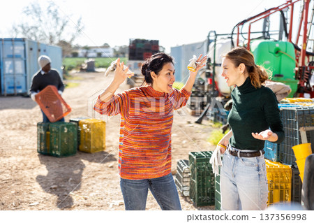Dissatisfied Asian woman farmer reprimanding young female worker Dissatisfied Asian woman farmer reprimanding young female worker 137356998