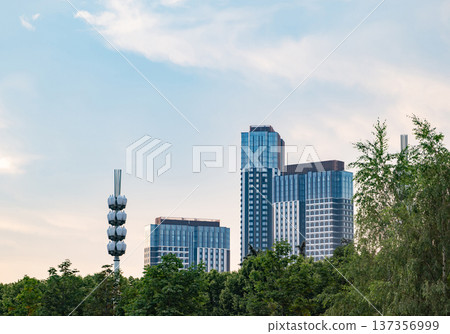 Modern city skyline from park with skyscrapers and communication tower Modern city skyline from park with skyscrapers and communication tower 137356999
