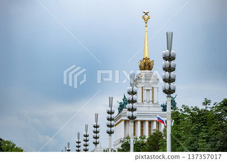 VDNKh Central Pavilion reflecting Soviet architecture with gold spire and Russian flag VDNKh Central Pavilion reflecting Soviet architecture with gold spire and Russian flag 137357017