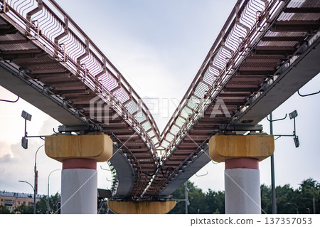 Monorail track splitting creating a junction, representing choice and divergent paths Monorail track splitting creating a junction, representing choice and divergent paths 137357053