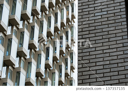 Modern building facade featuring bay windows and contrasting brick patterns Modern building facade featuring bay windows and contrasting brick patterns 137357135