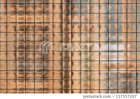Wired glass panel creating abstract background texture with warm translucent light Wired glass panel creating abstract background texture with warm translucent light 137357207