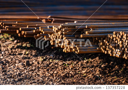 Stacked rusty rebar reinforcing steel bars ready for construction on an industrial site 137357228