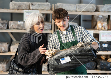 Older woman choosing mycelium in a garden store 137357264