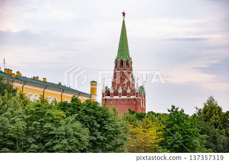 Kremlin's Troitskaya Tower with red star rising above lush green trees in Moscow 137357319