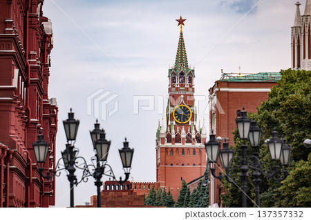 Spasskaya tower clock on Moscow Kremlin with Red Square buildings and street lanterns Spasskaya tower clock on Moscow Kremlin with Red Square buildings and street lanterns 137357332