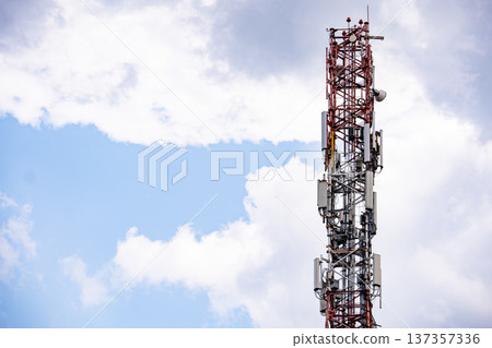 Telecommunication tower providing cellular and mobile signal coverage against a cloudy sky Telecommunication tower providing cellular and mobile signal coverage against a cloudy sky 137357336