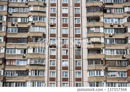 Apartment building facade highlighting urban dwelling and high-rise living Apartment building facade highlighting urban dwelling and high-rise living 137357366